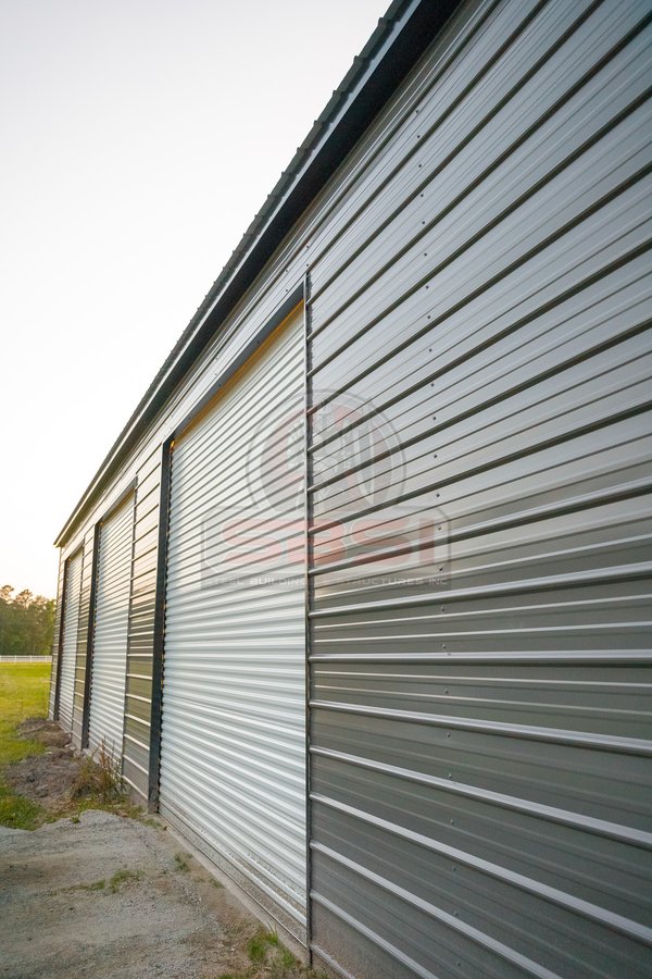 Side view of workshop with 3 garage doors